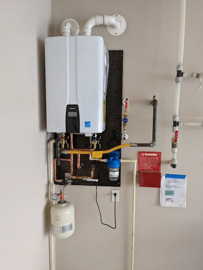 Professional plumber installing copper piping in a Miamisburg home